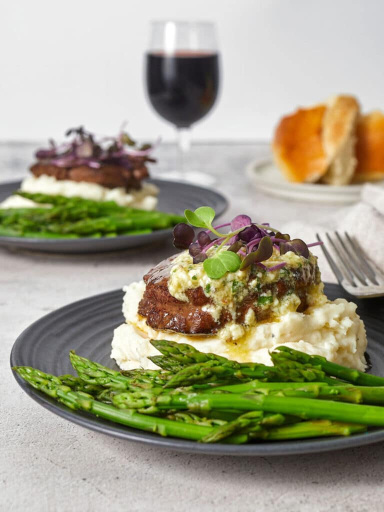 Plated filet dinner with mashed potatoes and asparagus